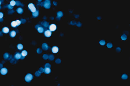 Beautiful and festive blurred lights in classic blue color of the year.の写真素材