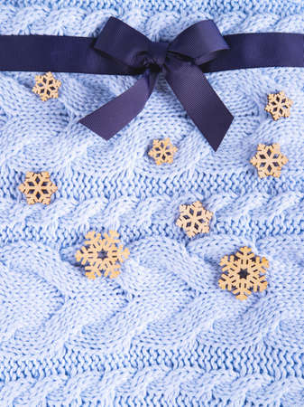 Beautiful wool knitted background in pale blue color made like a present with the ribbon and the...
