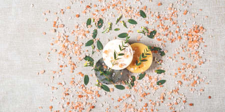 The beautiful picture of the round natural handmade soaps and bath salt with the twigs of eucalyptus...