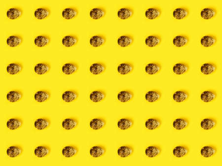 The easter background with the quail brown eggs pattern on the trendy yellow background.