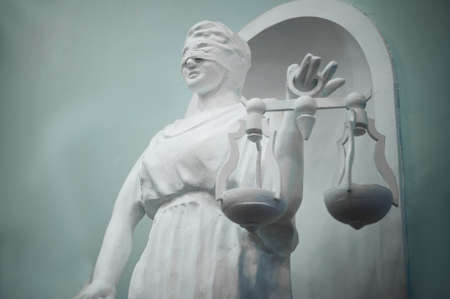 Statue of Justice. Statue made of plaster. White and blue color.の写真素材