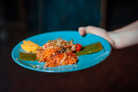 Food on the plate. A hand is holding a plate.の写真素材