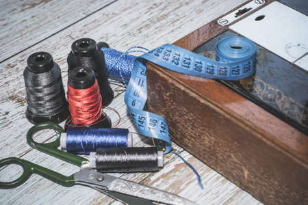 Sewing accessories sewing machine, colored threads, as well as scissors and measuring tape