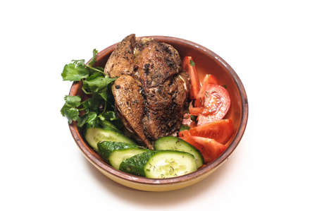 Meat with vegetables on a plate on a white background pork beef cucumber tomatoの写真素材