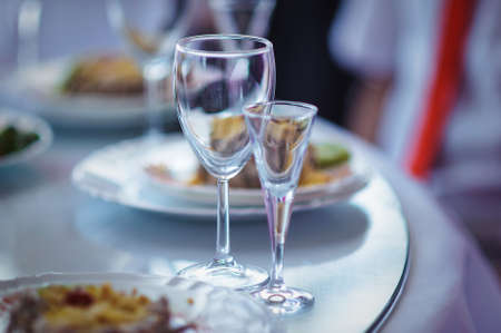 Empty wine glasses on served tableの写真素材