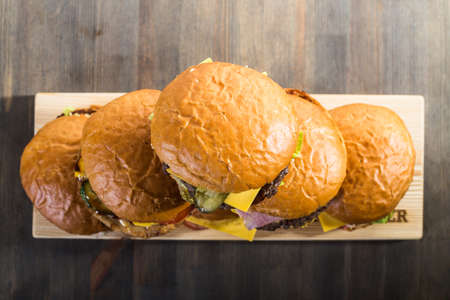 Pyramid of six crafting burgers on the boardの写真素材