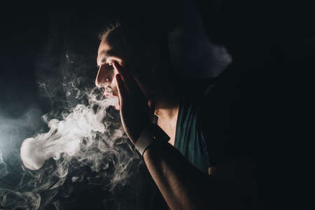 The man smoke an electronic cigarette or hookahの写真素材