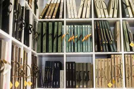 many wallpaper catalogs over books on shelves - wallpapers. on the shelf. close