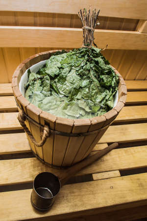 natural bath broom in a sauna in a wooden barrelの写真素材