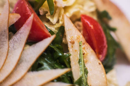 Delicious salad with gorgonzola, pear and cherry tomatoes close-upの写真素材