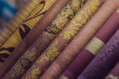 Rolls of different kinds of wallpaper closeの写真素材