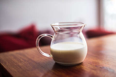 A jug of milk on wooden tableの写真素材