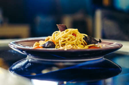Pasta with chicken and tomatoes on a plate another viewの写真素材