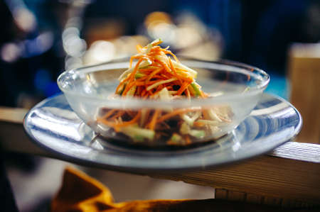 Green salad with lettuce, carrot and onion on the plateの写真素材