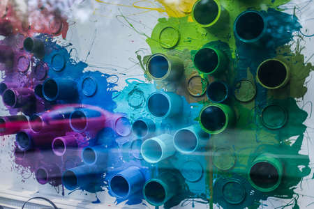 cans and colors drop on the wall for the backgroundの写真素材