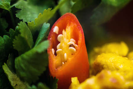 chicken curry with greens in a brown bowl on a board on a white background closeの写真素材