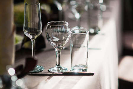 Empty glasses set in restaurant, empty wine glasses on the table different typeの写真素材