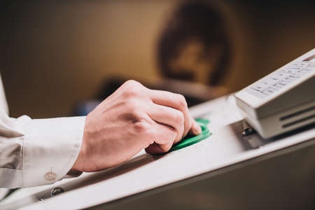 Hands setting up medical equipment. Exterior of hyperbaric recompression chamber.の写真素材