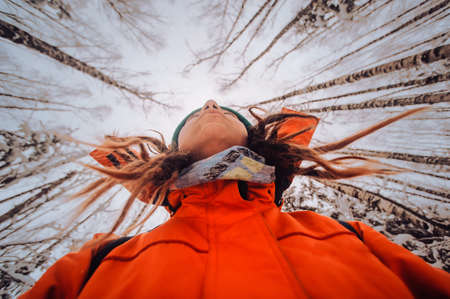Winter sport activity. Woman hiker hiking with backpack and snowshoes snowshoeing on snow trail forest in Russia, at sunset. one more another selfieの写真素材