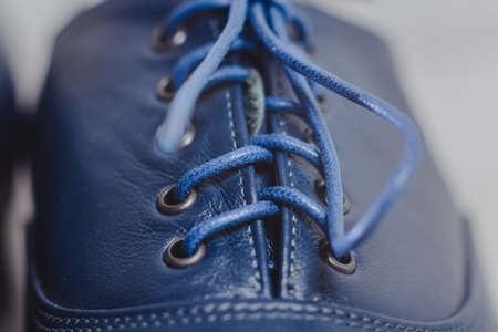 Stylish blue man's crafted shoes with laces from skin and suede. macro photography of crafted men's blue boots made of genuine leather. laces macro view closeの写真素材