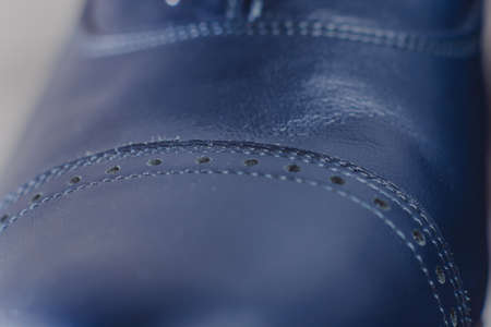 Stylish blue man's crafted shoes with laces from skin and suede. macro photography of crafted men's blue boots made of genuine leather. skin textureの写真素材