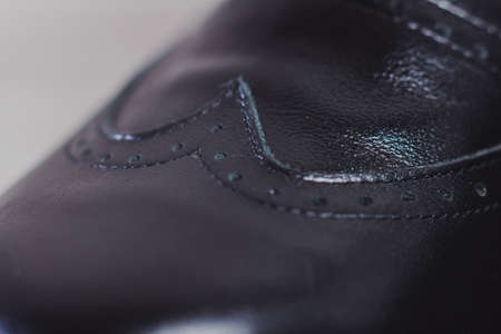 Stylish black man's crafted shoes for ballroom dancing with laces from skin and suede on the wooden...