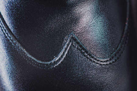 Stylish black man's crafted shoes for ballroom dancing with laces from skin and suede on the wooden background. photography of men's black boots for ballroom dancing. macroの写真素材