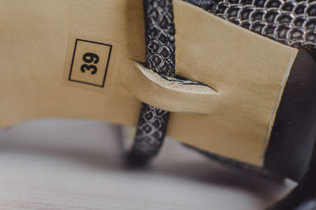 hand-made women's dance shoes made of genuine leather on the wooden surface macro photography