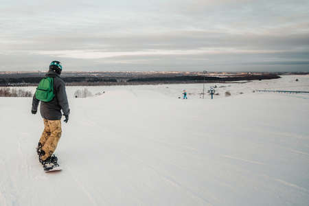 Snowboarder rides over fresh snow on the slope in winter, extreme sportの写真素材
