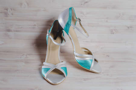 hand-made women's dance shoes made of genuine leather on the wooden surface macro photography....