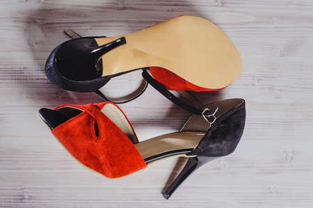 hand-made women's dance shoes made of genuine leather on the wooden surface macro photography. red colored style closeupの写真素材