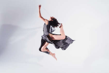 Modern teen contemporary dancer poses in front of the studio background.の写真素材