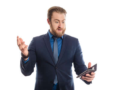 Handsome businessman in a blue business suit standing isolated against white background with smart phone. surprised another viewの写真素材