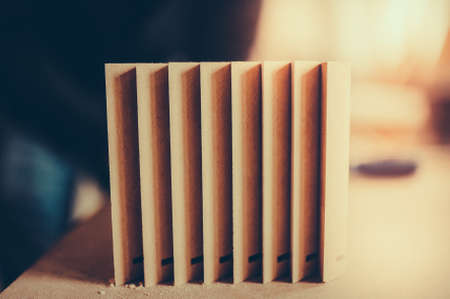 A stack of wooden furniture items on the table. Toned image.の写真素材