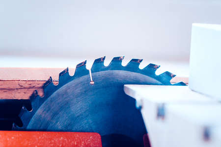 Saws furniture details with a circular saw. Toned image. close up viewの写真素材