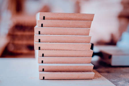 A stack of wooden furniture items on the table. Toned image.の写真素材