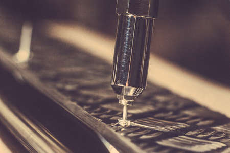 Man is working with a pneumatic rivet gun. Toned image. Workman installs a rivet with a pop rivet gun. close up viewの写真素材