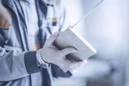 Carpenter working on woodworking machines in carpentry shop. Toned image. Man collects furniture boxes. close upの写真素材