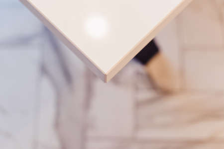 Modern kitchen white furniture with a table top made of natural stone. Advertising photography of kitchen interior. View of kitchen table corner from the topの写真素材