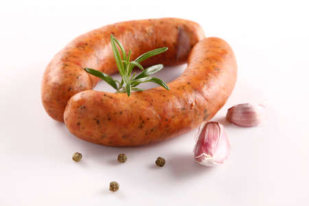 Tasty sausages with spices on whiteの写真素材