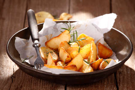 Baked potatoes with rosemaryの写真素材