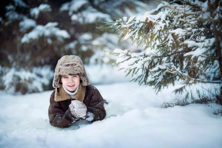 Little child boy having fun in the snowの写真素材