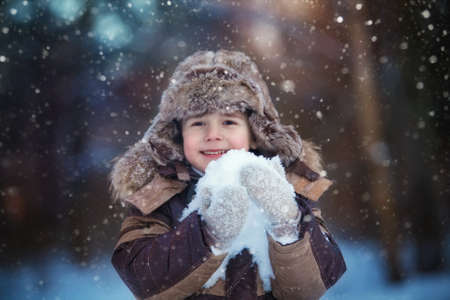 Little child boy having fun in the snowの写真素材