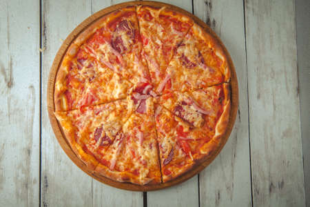 round pizza with chicken, with mozzarella, cheese, and basil on a board top viewの写真素材