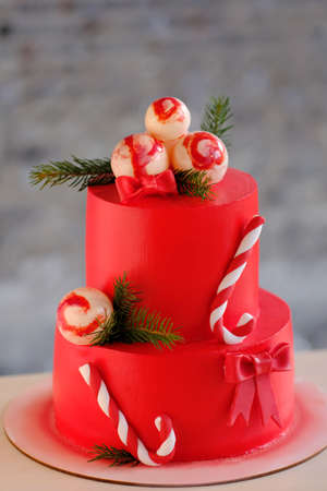 Red cake with balls and fir branchesの写真素材