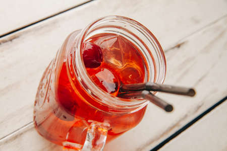 cocktail with ice in a bar on a wooden dlsky backgroundの写真素材