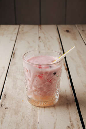 cocktail with ice in a bar on a wooden dlsky backgroundの写真素材