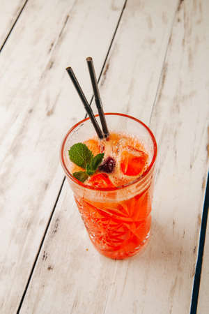 cocktail with ice in a bar on a wooden dlsky backgroundの写真素材