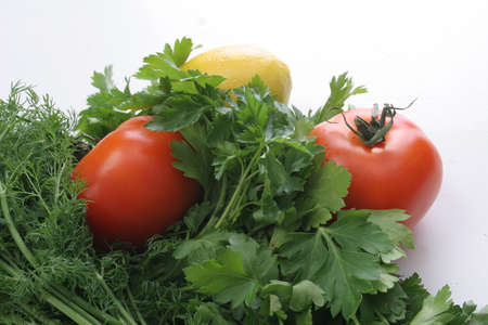 vegetables and greens on a white background, dill, parsley, tomatoes and lemonの写真素材
