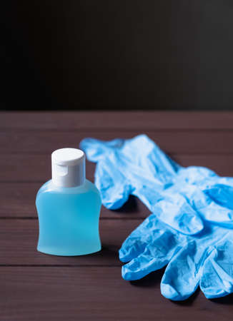 medical latex gloves, a bottle of antiseptic liquid on a brown background against the new coronavirus or coronavirusの写真素材